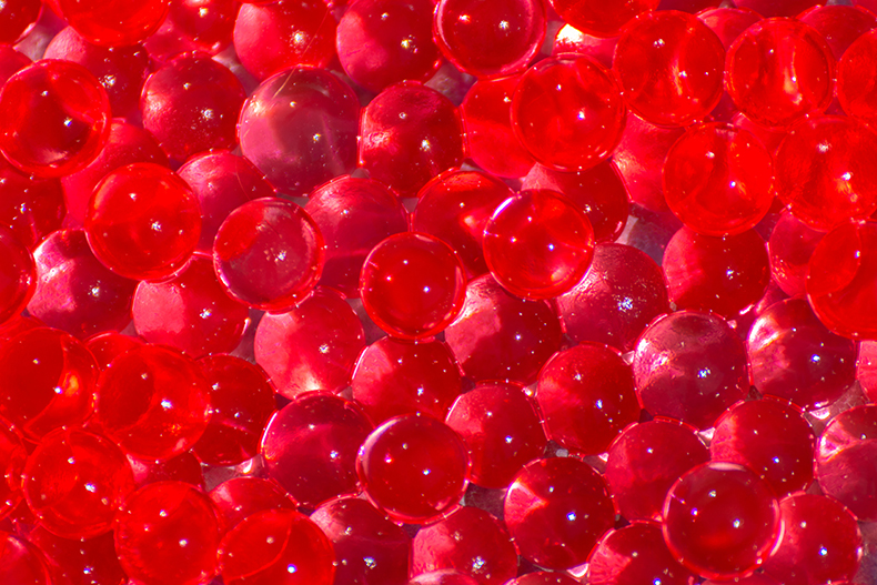 Close up of red polymer particles