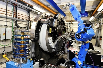 Inside the I11 high-resolution powder diffraction beamline at Diamond Light Source, the carousel is viaible to the foreground and a robot arm to the right