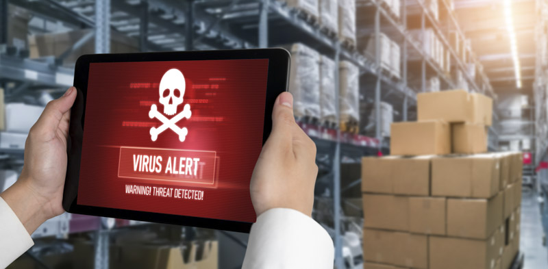 Virus warning on a computer tablet in a warehouse setting