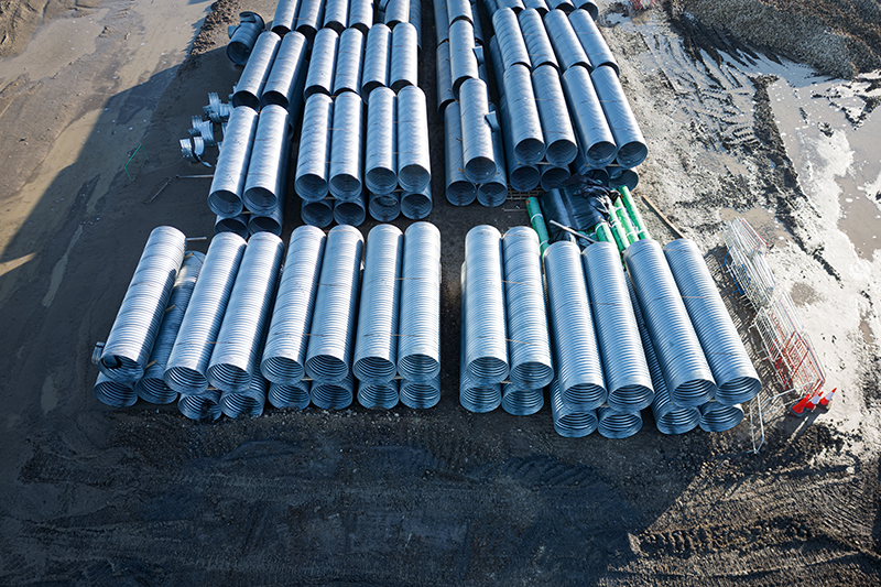 Rows of steel water and irrigation pipes at a UK reservoir construction site