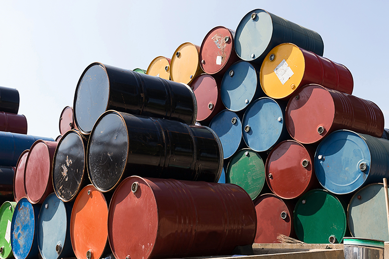 Stock image of rows of different coloured barrels stacked on top of each other