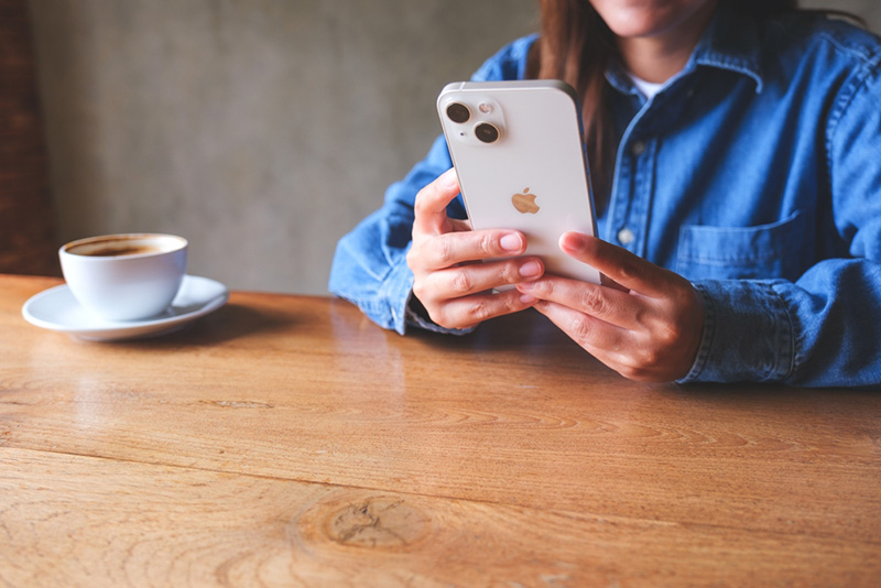 Woman looking at her Apple smartphone