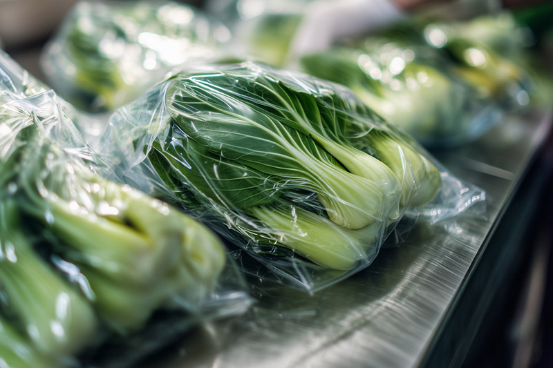 An AI-generated image of pak choi in vacuum-packed transparent, plastic bags