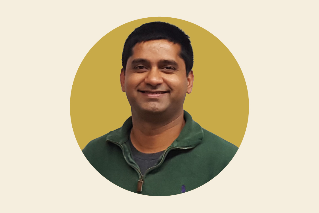 Headshot of Dijam Panigrahi against a mustard yellow background