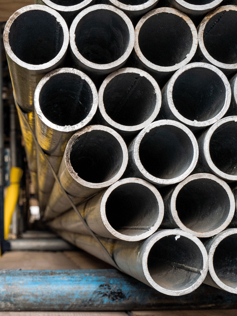 steel pipes strapped down on a transporter