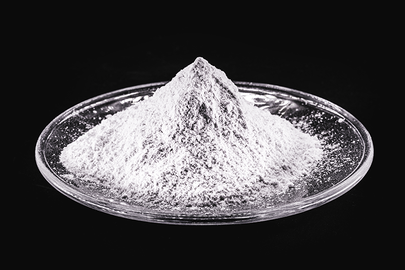 A pile of white-coloured phosphate powder in a glass dish