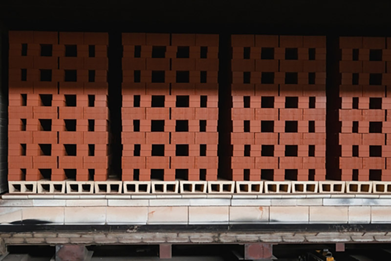 Bricks that have been fired in a kiln drying in an oven