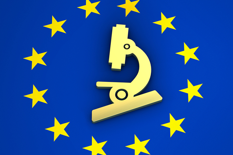 Blue background with yellow stars as in European flag, centre of the flag shows a microscope in a slightly lighter yellow