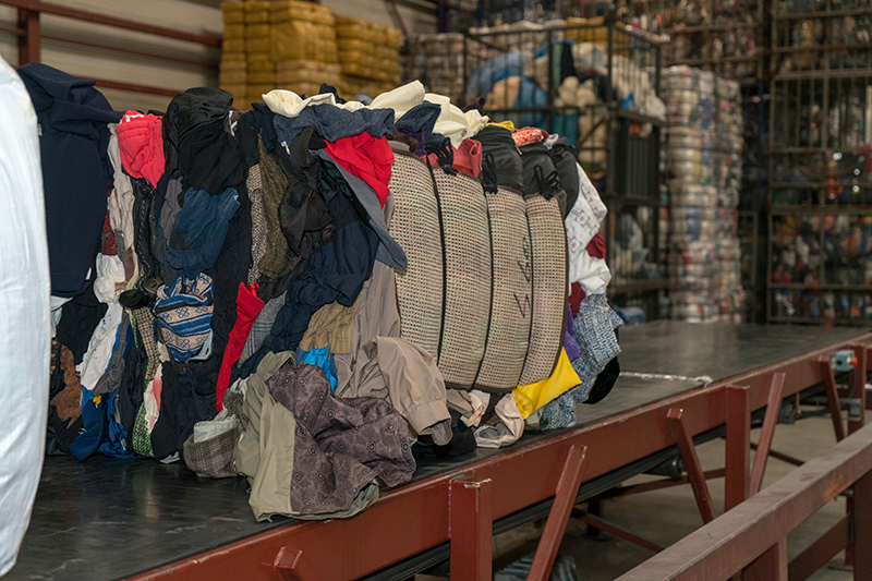 Stock image of a bundle of wholesale used textiles in different colours