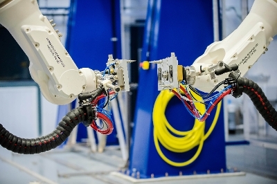 Two robots mirror each other in the Certification, Inspection and Verification Cell