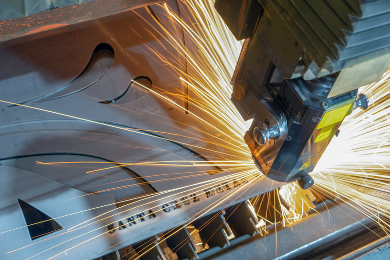 piece of metal and a metal grinder with flying sparks