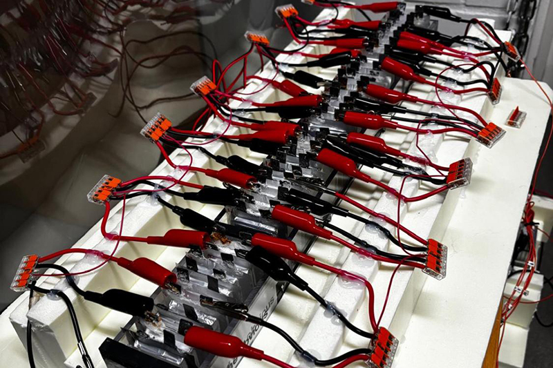 A lab module of the supercapacitor technology with red wires plugged into it