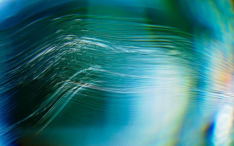 blue green background with white ripples over the top