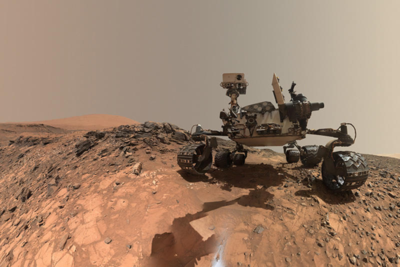 Mars Curiosity rover taking a selfie standing on Mars red rock
