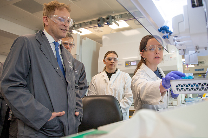 Three people in a laboratory
