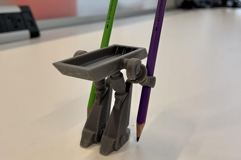 A pencil holder and two pencils